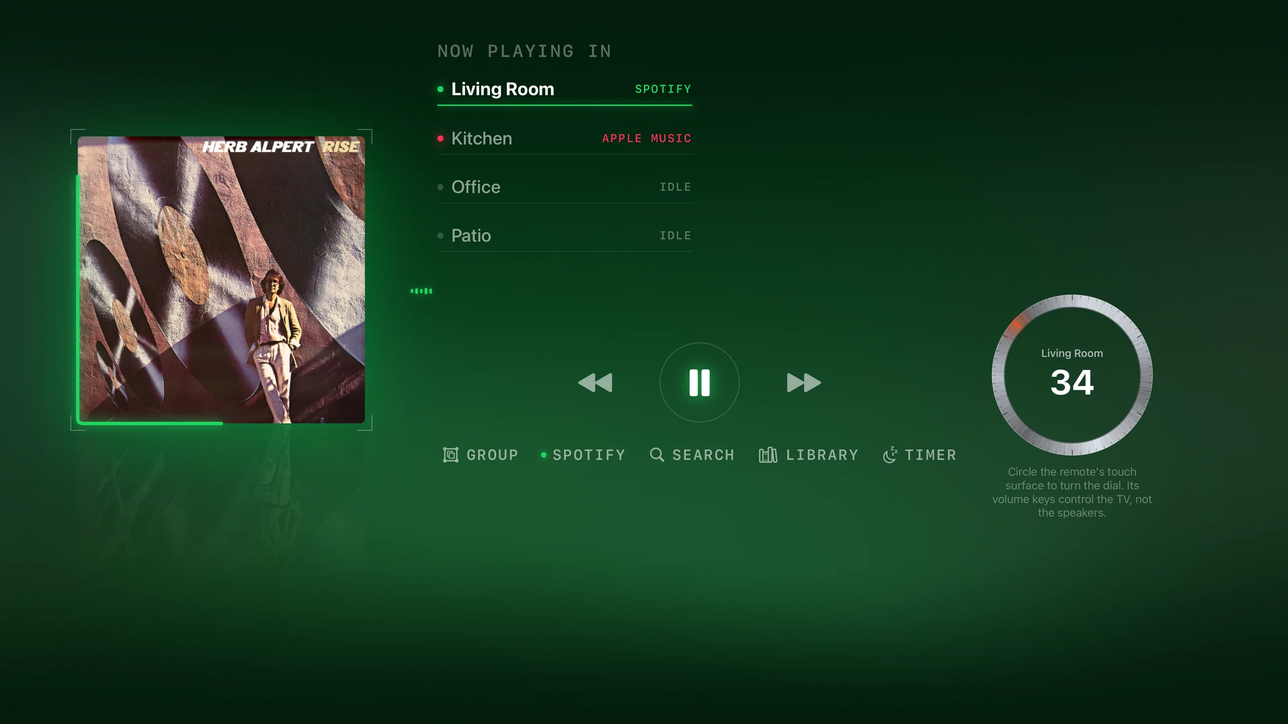 Dial now-playing screen: album cover left, every room listed with what it is playing, transport controls, and the brushed-steel volume dial reading 34 with one ember tick at the level